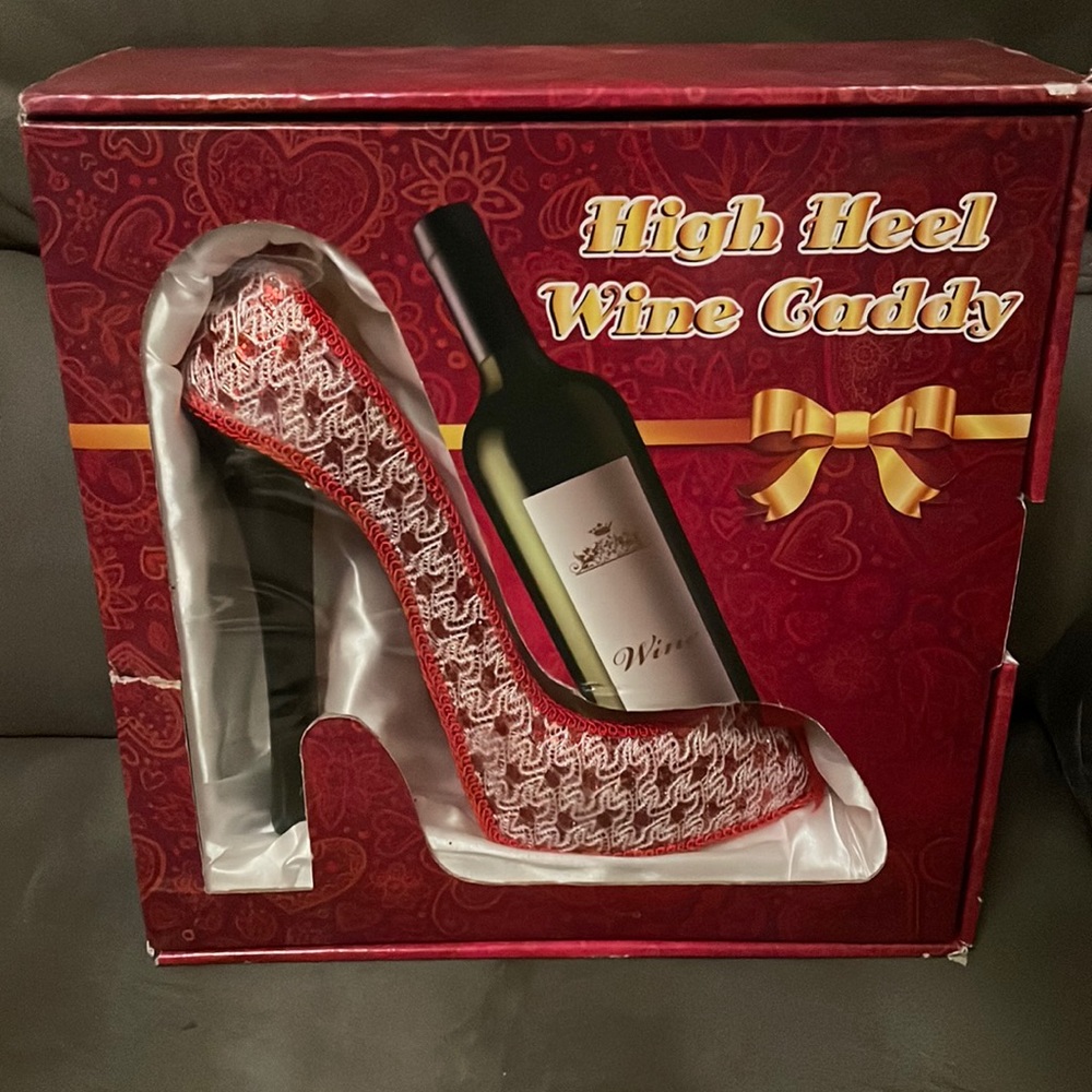Gently used comes in box, High Heel Wine Caddy.